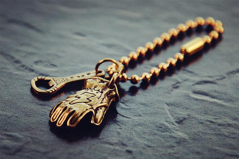 Vintage motorcycle gear-inspired brass keychain