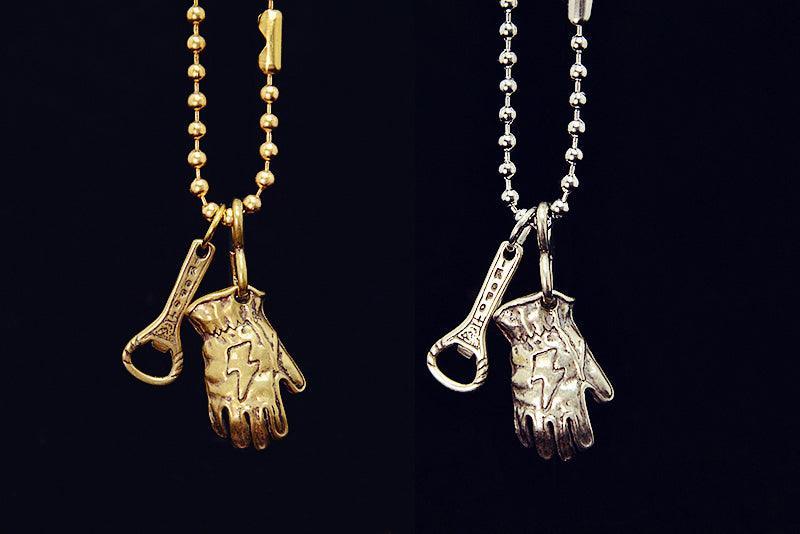 Vintage brass rider glove keychain accessory close-up